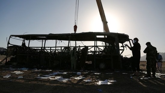The wreckage of a bus is towed at the site of a crash in Guzara district of Herat province on August 20, 2025. (AFP)