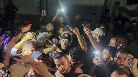 Palestinians hold the body of Al Jazeera journalist Anas Al-Sharif, who Israel's military and Al Jazeera say was killed by an Israeli strike, in Gaza City, August 11, 2025.(REUTERS)