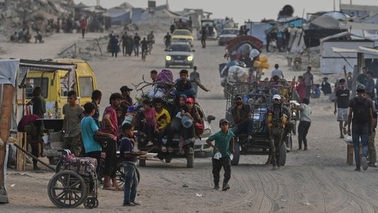 Displaced Palestinians travel on carts and vehicles through a makeshift camp along the beach in Gaza City, Sunday, Aug. 10, 2025. (AP)