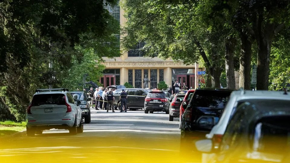 Law enforcement officers gather outside Annunciation Church following a mass shooting event in Minneapolis on Wednesday. - Tim Evans/Reuters