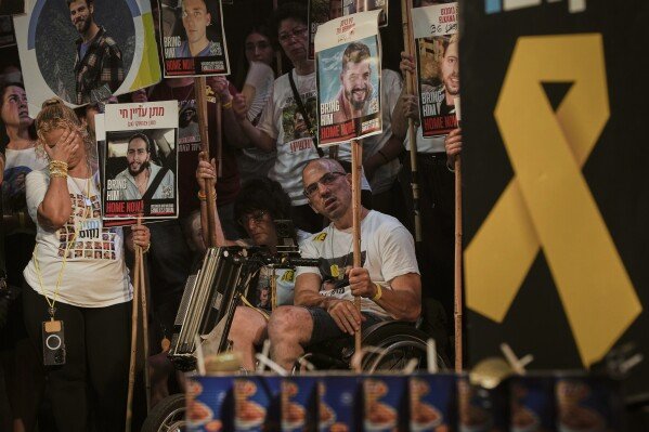 Relatives and supporters of Israeli hostages held in the Gaza Strip attend a rally demanding their release from Hamas captivity and calling for an end to the war, in Tel Aviv, Israel, Saturday, Aug. 9, 2025. (AP Photo/Ohad Zwigenberg)