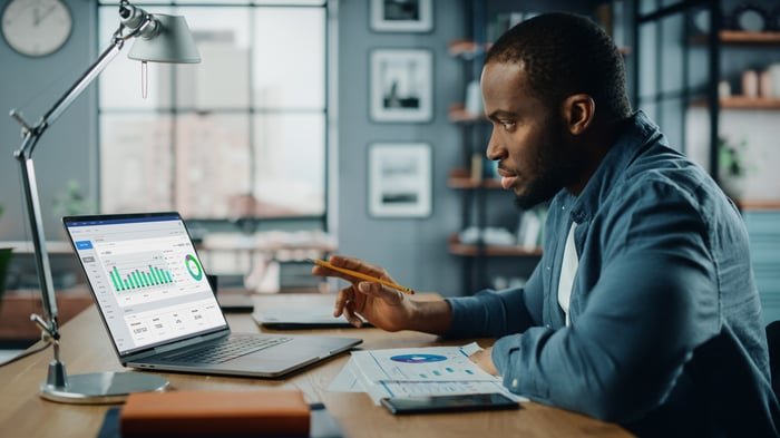 Person looking at stock data on a tablet.