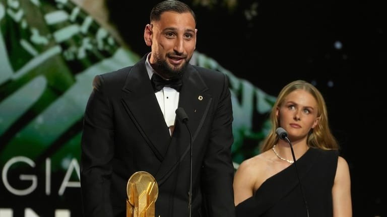 Paris Saint-Germain's Gianluigi Donnarumma receives the Yashin Trophy during the...