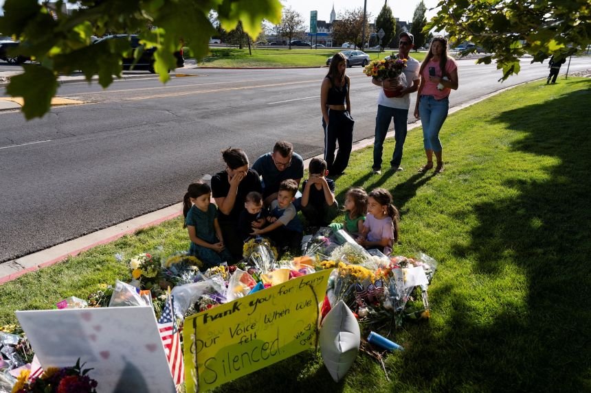 People visit a makeshift memorial for Charlie Kirk at Utah Valley University in Orem, Utah, on September 11, 2025.