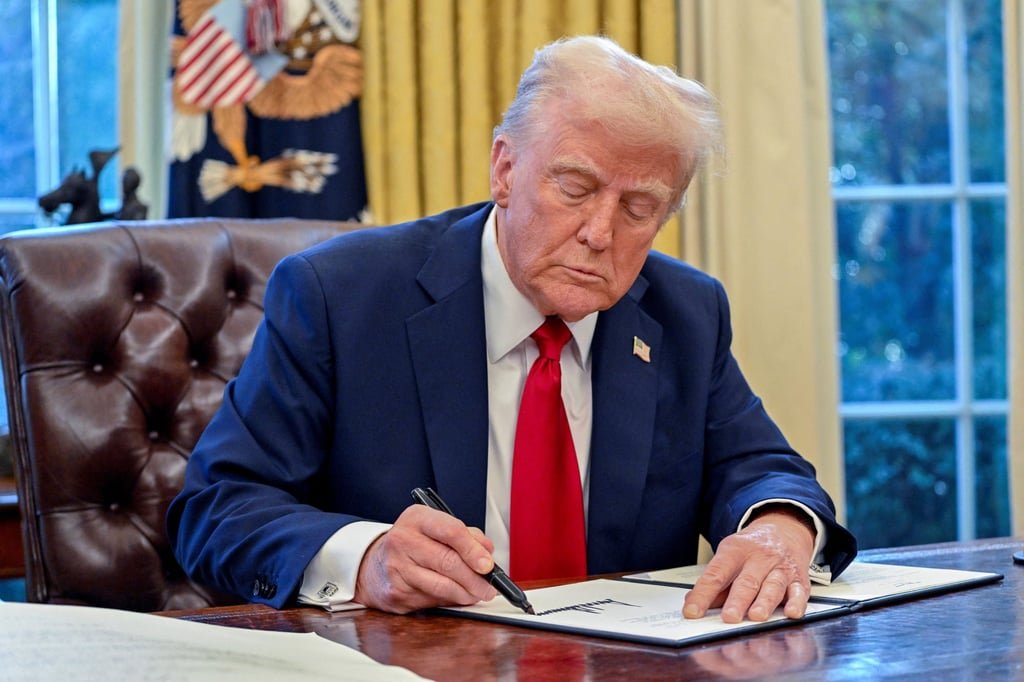 US President Donald Trump signs an executive order in the Oval Office of the White House on January 30. A West Kowloon senior executive at the top of the pay scale takes home over HK$6 million, more than a US president. Photo: TNS