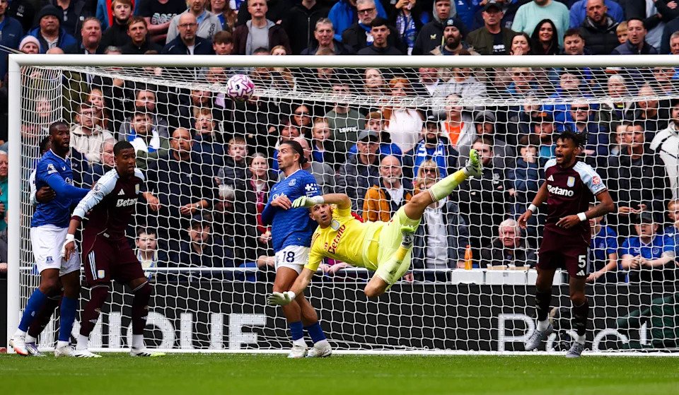 Aston Villa goalkeeper Emiliano Martinez clears under pressure from Everton's Jack Grealish during the Premier League match at the Hill Dickinson Stadium, Liverpool. Picture date: Saturday September 13, 2025. (Photo by Tim Markland/PA Images via Getty Images)
