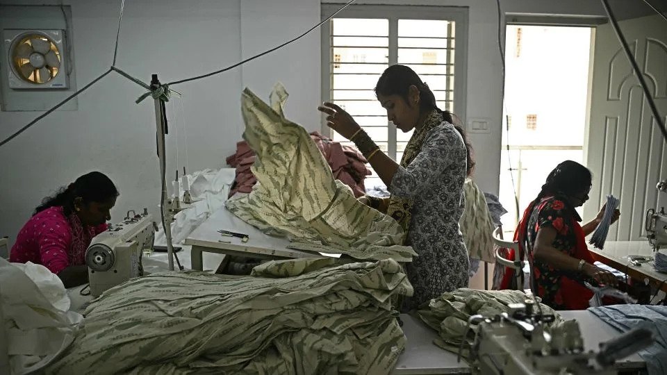 Garment workers sort clothing material for dresses at an apparel manufacturing unit in Bengaluru, India, on August 25, 2025. US President Donald Trump has threatened to double import duties on India from 25% to 50% by August 27 to punish New Delhi for buying oil from Russia, saying the purchases help Moscow fund its invasion of Ukraine. - Idrees Mohammed/AFP/Getty Images