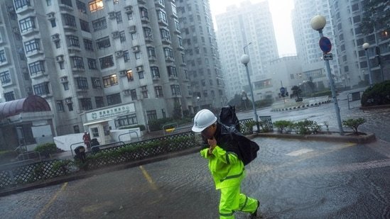 A worker braves the wind while wading through floodwaters in the Heng Fa Chuen residential area during Super Typhoon Ragasa in Hong Kong, China, on Wednesday, Sept. 24, 2025.(Bloomberg)