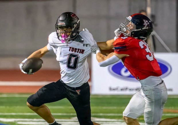 Tustin wide receiver Hayden Koo pushes Yorba Linda cornerback Thomas Knutson away after catching a pass in a nonleague football game in Yorba Linda on Friday, Sept. 19, 2025. (Photo by Paul Rodriguez, Contributing Photographer)