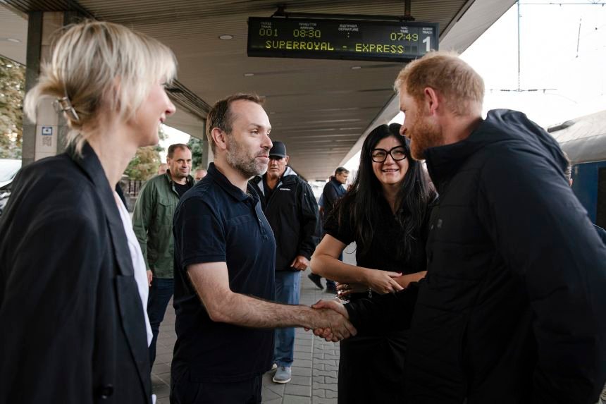 Britain's Prince Harry is greeted at the central railway station in Kyiv, Ukraine, on Friday.