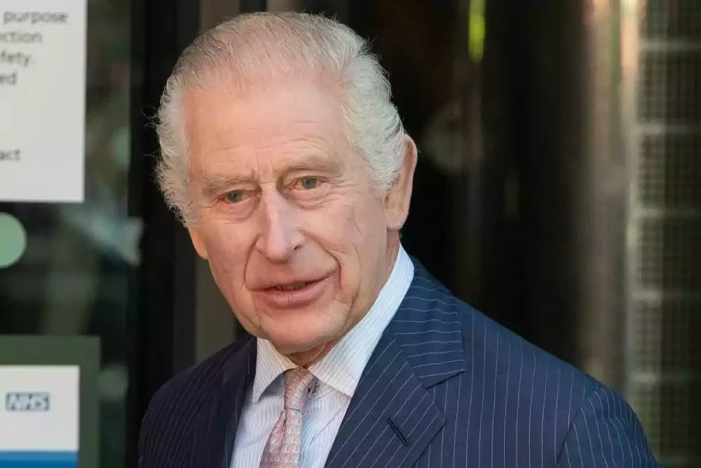 Older man with gray hair and a pinstripe suit posing outdoors