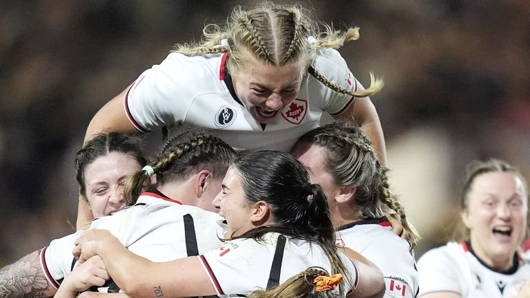 Canada's Courtney O'Donnell and team-mates celebrate after winning the Women's Rugby World Cup semi-final against New Zealand