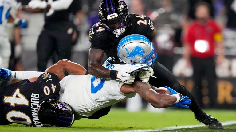 Detroit Lions running back Jahmyr Gibbs (0) tries to cross the goal line as Baltimore Ravens linebacker Teddye Buchanan (40) and safety Malaki Starks (24) try to stop him during the first half of an NFL football game Monday, Sept. 22, 2025, in Baltimore. (AP Photo/Stephanie Scarbrough)
