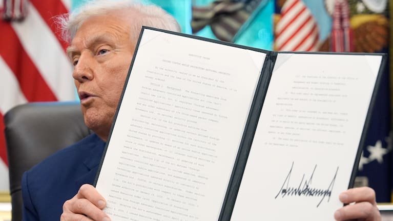 President Donald Trump holds a signed executive order regarding TikTok in the Oval Office at the White House, Thursday, Sept. 25, 2025, in Washington.