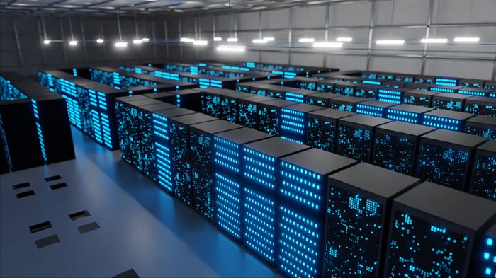 Data center filled with rows of computer server racks.