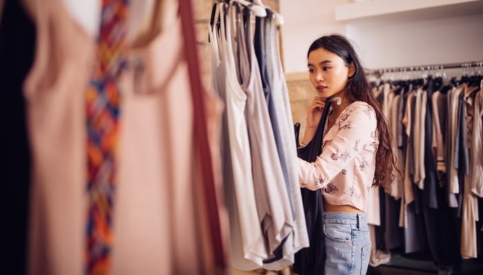 Person shopping for clothes in a retail store.