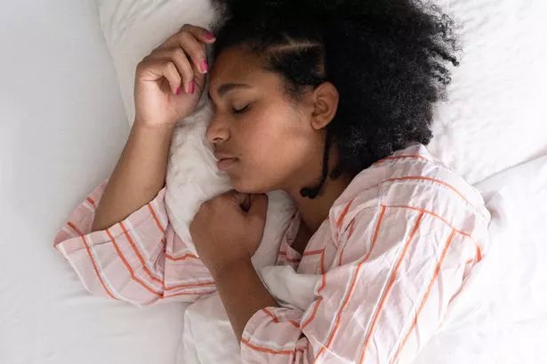 Young woman in bed sleeping peacefully