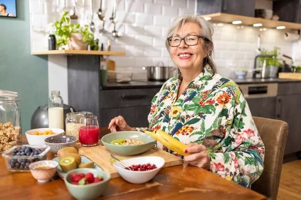 A woman enjoying a variety of breakfast foods
