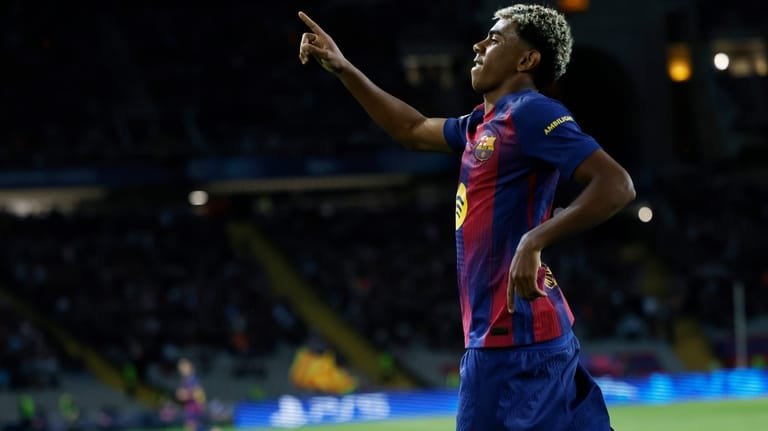 Barcelona's Lamine Yamal celebrates after scoring his side's third goal...