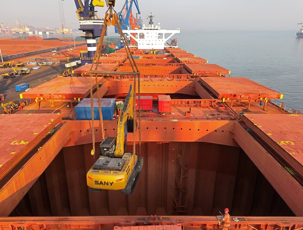 A crane loads a Sany digger onto a cargo ship at a port in Yantai in east China’s Shandong province. Photo: Feature China/Future Publishing via Getty Images