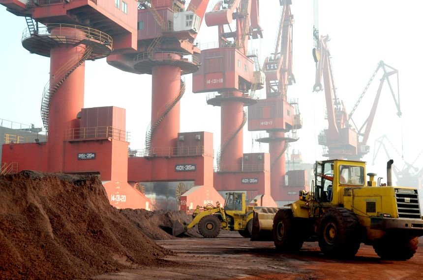 Workers transport soil containing rare earths elements for export at a port in Lianyungang, Jiangsu province, China, on October 31, 2010.