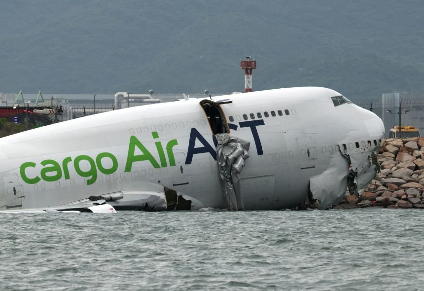 A cargo plane lies partially in the sea after veering off the runway during landing at Hong Kong International Airport in Hong Kong on Monday.