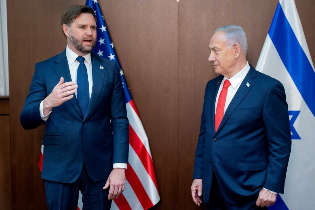 JD Vance and Benjamin Netanyahu standing in front of the U.S. and Israeli flags.
