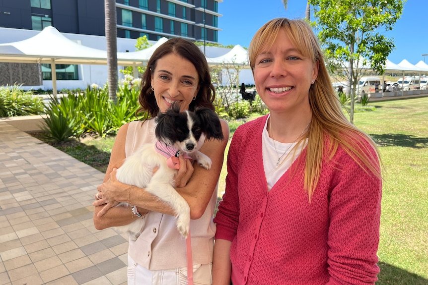 Two women and a small puppy.