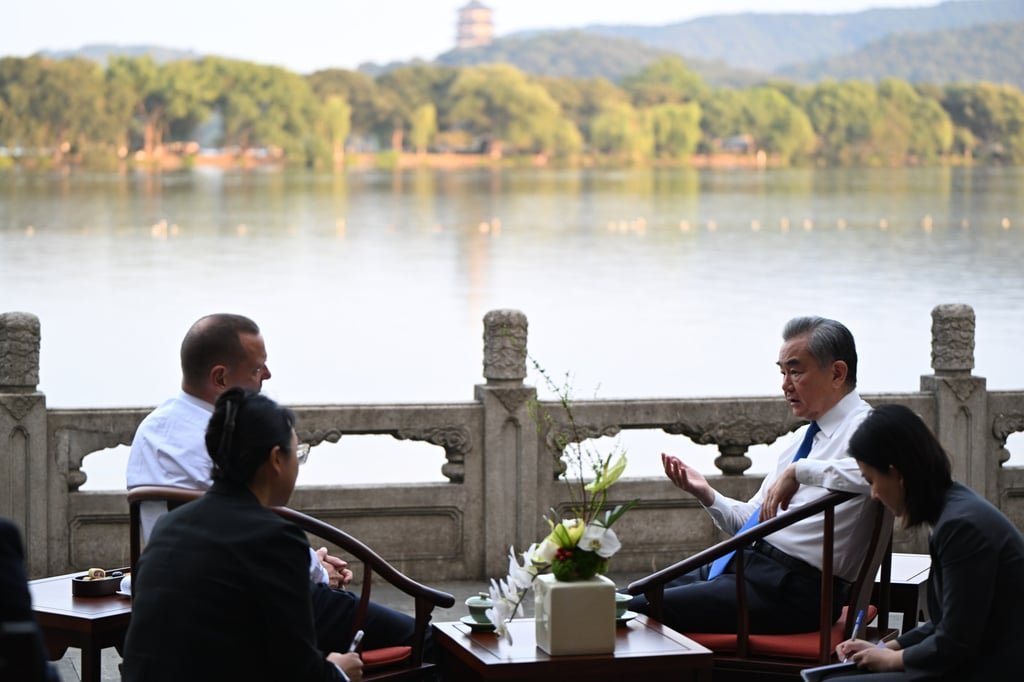Emmanuel Bonne, diplomatic adviser to the French President, and Chinese Foreign Minister Wang Yi during discussions in Hangzhou, eastern China on Wednesday. Photo: Xinhua
