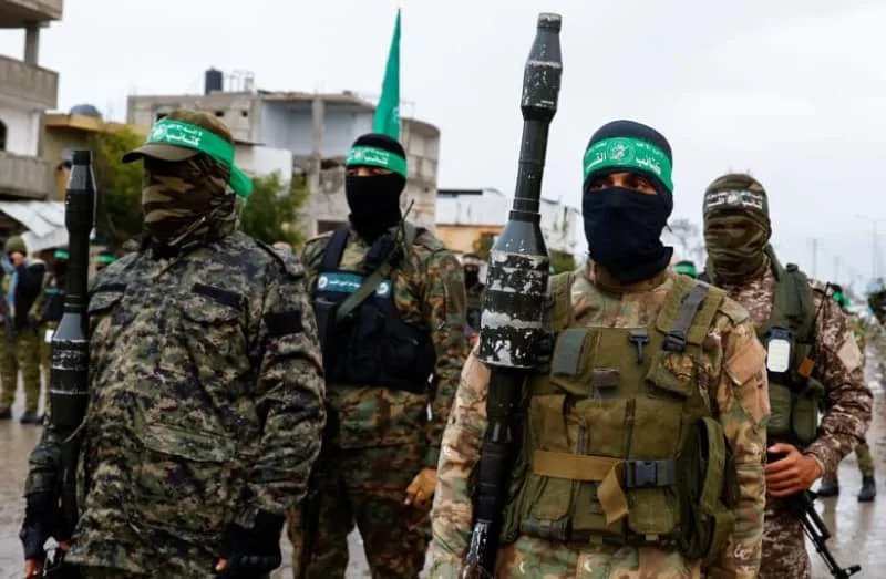 Palestinian Hamas terrorists stand guard on the day of the handover of hostages held in Gaza since the deadly October 7 2023 attack, as part of a ceasefire and a hostages-prisoners swap deal between Hamas and Israel, in Rafah in the southern Gaza Strip, February 22, 2025. (credit: REUTERS/Hatem Khaled)