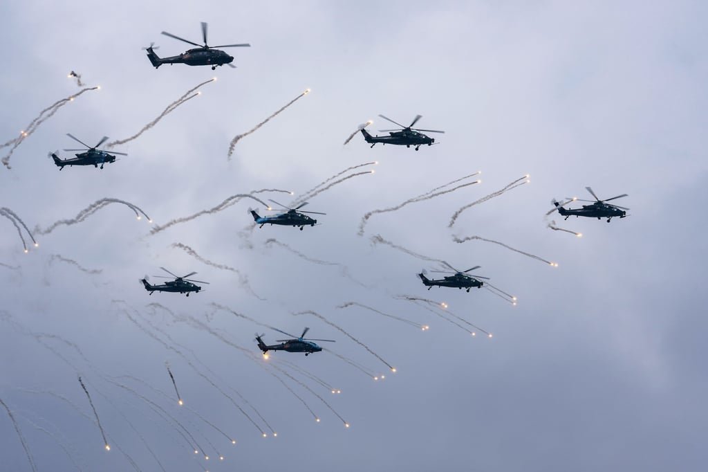 A PLA aerobatic team fires flares during a military air show in Tianjin on Thursday. Photo: EPA