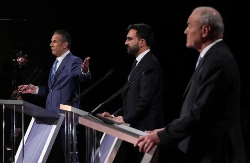 Former Gov. Andrew Cuomo gestures toward Curtis Sliwa and Zohran Mamdani during the second NYC mayoral debate at LaGuardia Performing Arts Center in Queens, October 22, 2025. (credit: Hiroko Masuike/Pool via REUTERS)