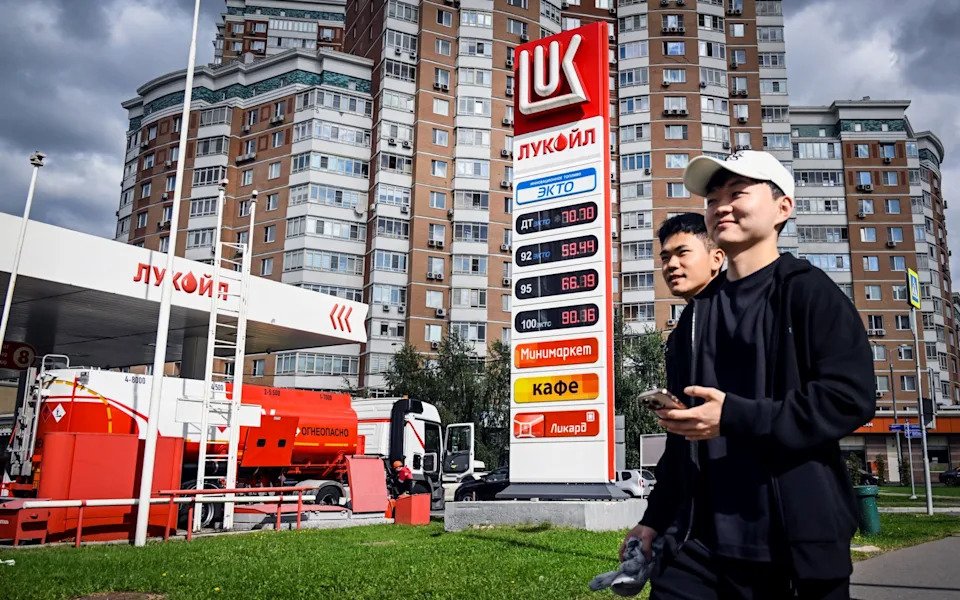 People walk past a petrol station in Moscow on September 8, 2025
