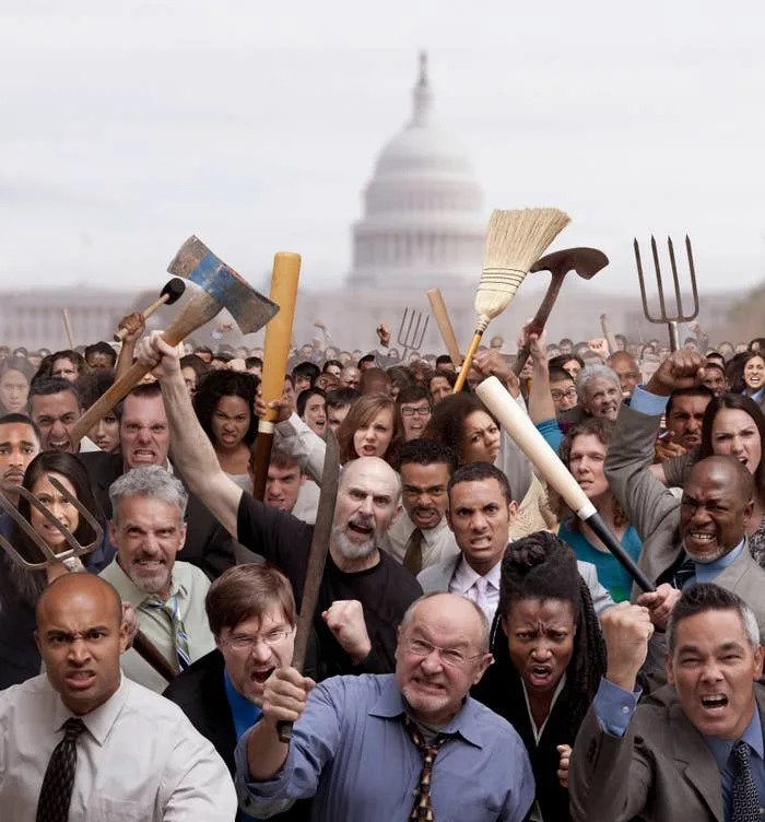 A diverse group of people energetically protest near a government building, holding various tools and displaying expressions of determination