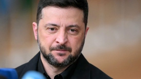 Ukraine's President Volodymyr Zelensky talks to the press as he arrives for a European Council meeting gathering the 27 EU leaders to discuss Ukraine.(AFP)