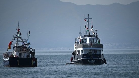 A ship (R), known as the "Family" and is part of the Global Sumud Flotilla, is anchored off the coast of the village of Sidi Bou Said on September 9, 2025. (Photo by FETHI BELAID / AFP)(AFP)