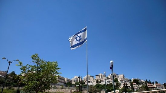 The Israeli national flag flutters as apartments are seen in the background in the Israeli settlement of Maale Adumim in the Israeli-occupied West Bank.(REUTERS File)