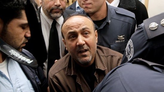 Jailed Fatah leader Marwan Barghouti (C) is accompanied by Israeli prison guards after a deliberation at Jerusalem Magistrate's court January 25, 2012.(REUTERS)