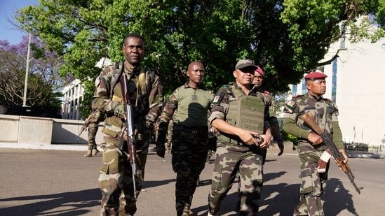 CAPSAT military unit commander Col. Michael Randrianirina, center, arrives at the Presidency to announce that the armed forces are taking control of the country in Antananarivo, Madagascar, Tuesday, Oct. 14, 2025. (AP Photo/ Brian Inganga)(AP)