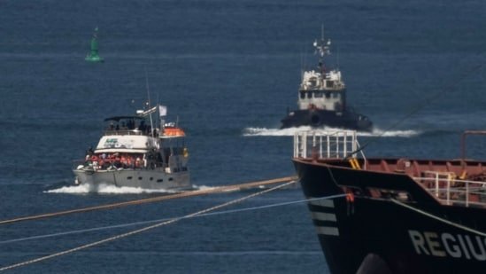 Israeli Navy vessels escort one of the boats from the civilian Gaza-bound flotilla Sumud after it was intercepted approaching the Gaza coast, toward the port of Ashdod.(AP)