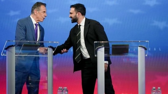 Andrew Cuomo, New York City mayoral candidate, left, and Zohran Mamdani, New York City mayoral candidate, shake hands during a mayoral debate in New York, US, on Thursday, Oct. 16, 2025. (Bloomberg)