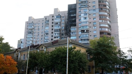 People walk past residential buildings damaged during a Russian drone and missile strike, amid Russia's attack on Ukraine, in Kyiv, October 22, 2025.(Reuters)