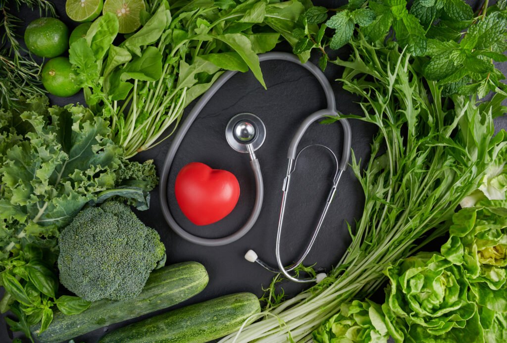 A stethoscope and a small heart are shown with produce.