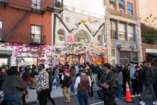 A crowd gathers outside Jean-Michel Basquiat's studio on Great Jones St. before a street co-naming ceremony for the iconic artist in Manhattan, New York on Tuesday, Oct. 21, 2025. (Gardiner Anderson / New York Daily News)