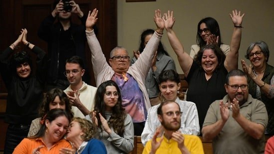 People celebrate the approval of the euthanasia law at the Legislative Palace in Montevideo.(AFP)