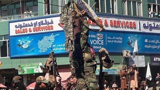 Afghan Taliban fighters display pants of Pakistani soldiers who allegedly fled their posts during the border clashes. (X/@Najib_Farhodi)
