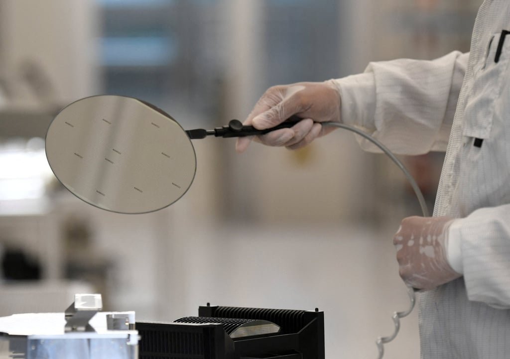 An employee works with a wafer in a production line of Nexperia. Photo: Reuters