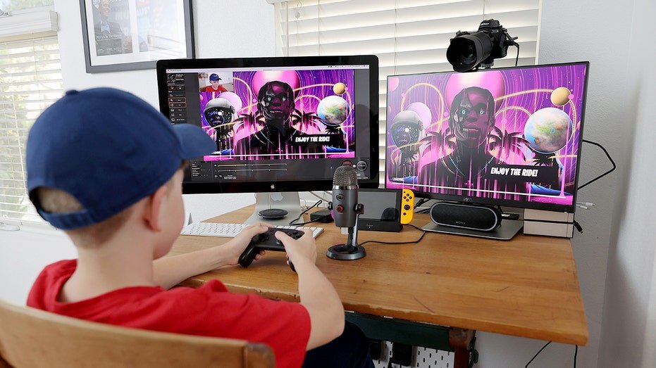 Boy plays Fortnite on a PC