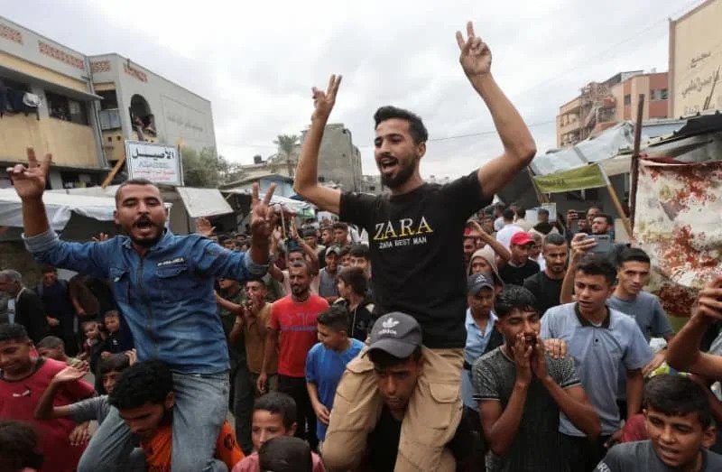 Palestinians celebrate, after US President Donald Trump announced that Israel and Hamas agreed on the first phase of a Gaza ceasefire, in Khan Yunis in the southern Gaza Strip October 9, 2025 (credit: REUTERS/Ramadan Abed)