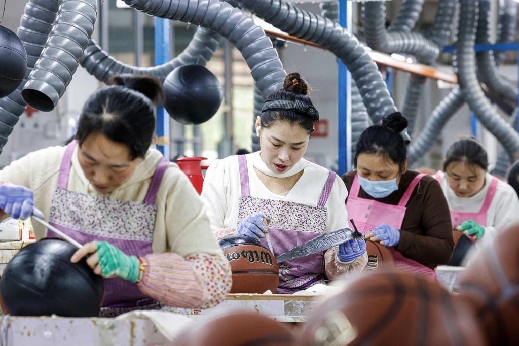 Employees produce basketballs that will be exported to Europe at a factory in Sihong, in eastern China’s Jiangsu province, on March 25. Photo: AFP